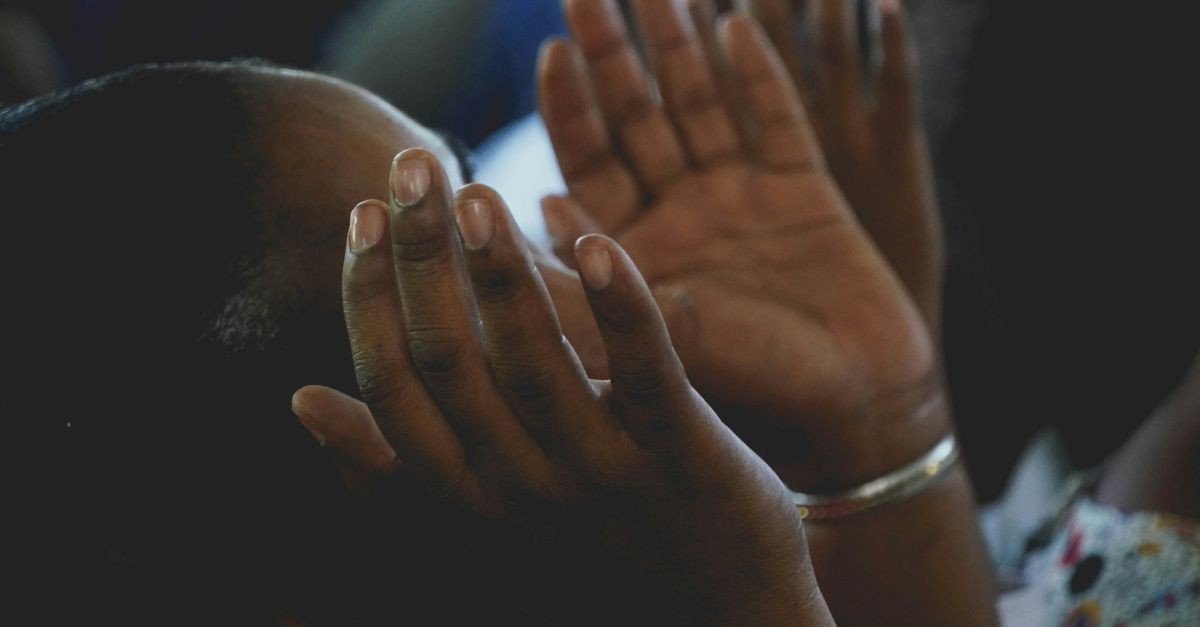 Woman praying; why do Christians pray?