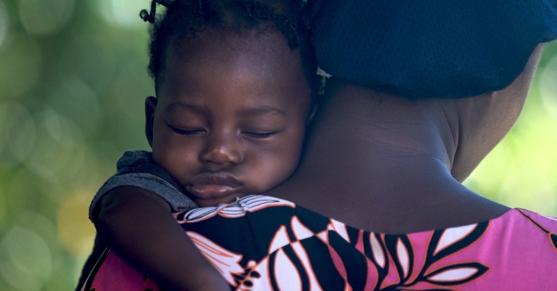 Baby asleep on mother's shoulder